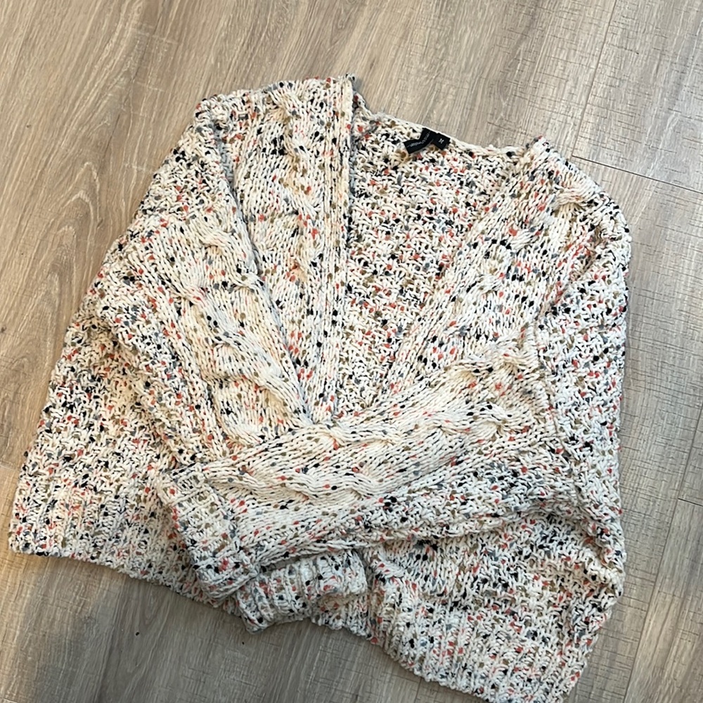 Soft white cardigan with bursts of colored fabric